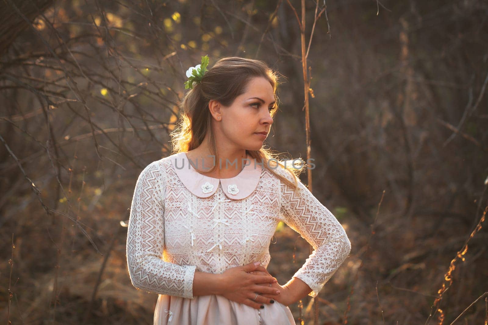 portrait of a girl in a field on a sunset background.