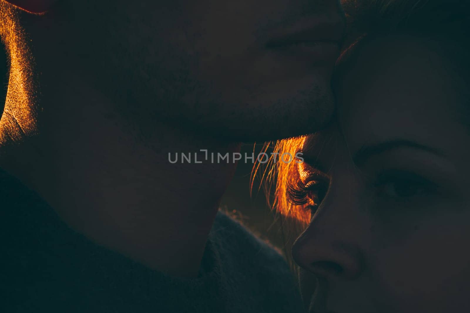 guy and girl in the field on the sunset background.