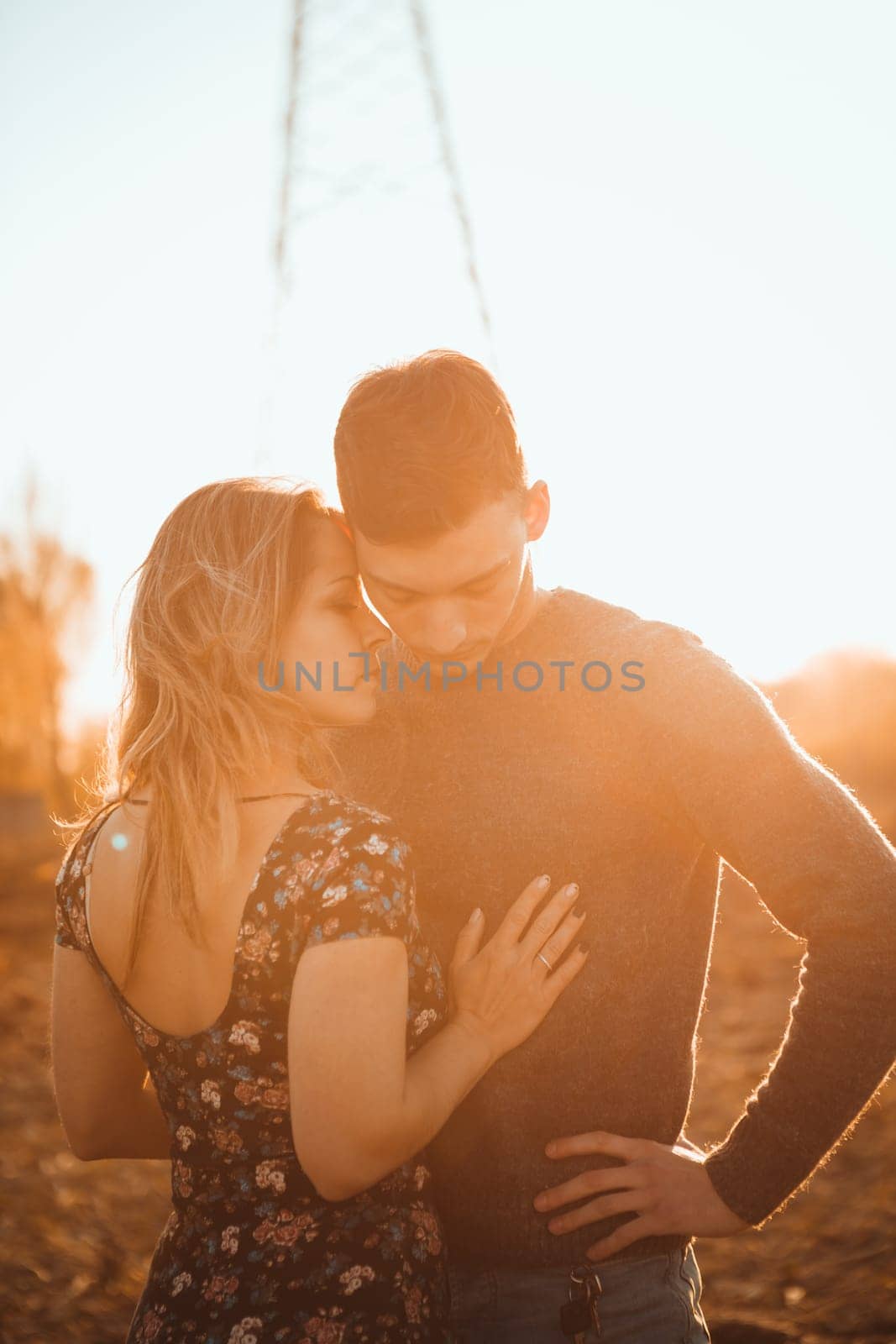 guy and girl in the field on the sunset background.