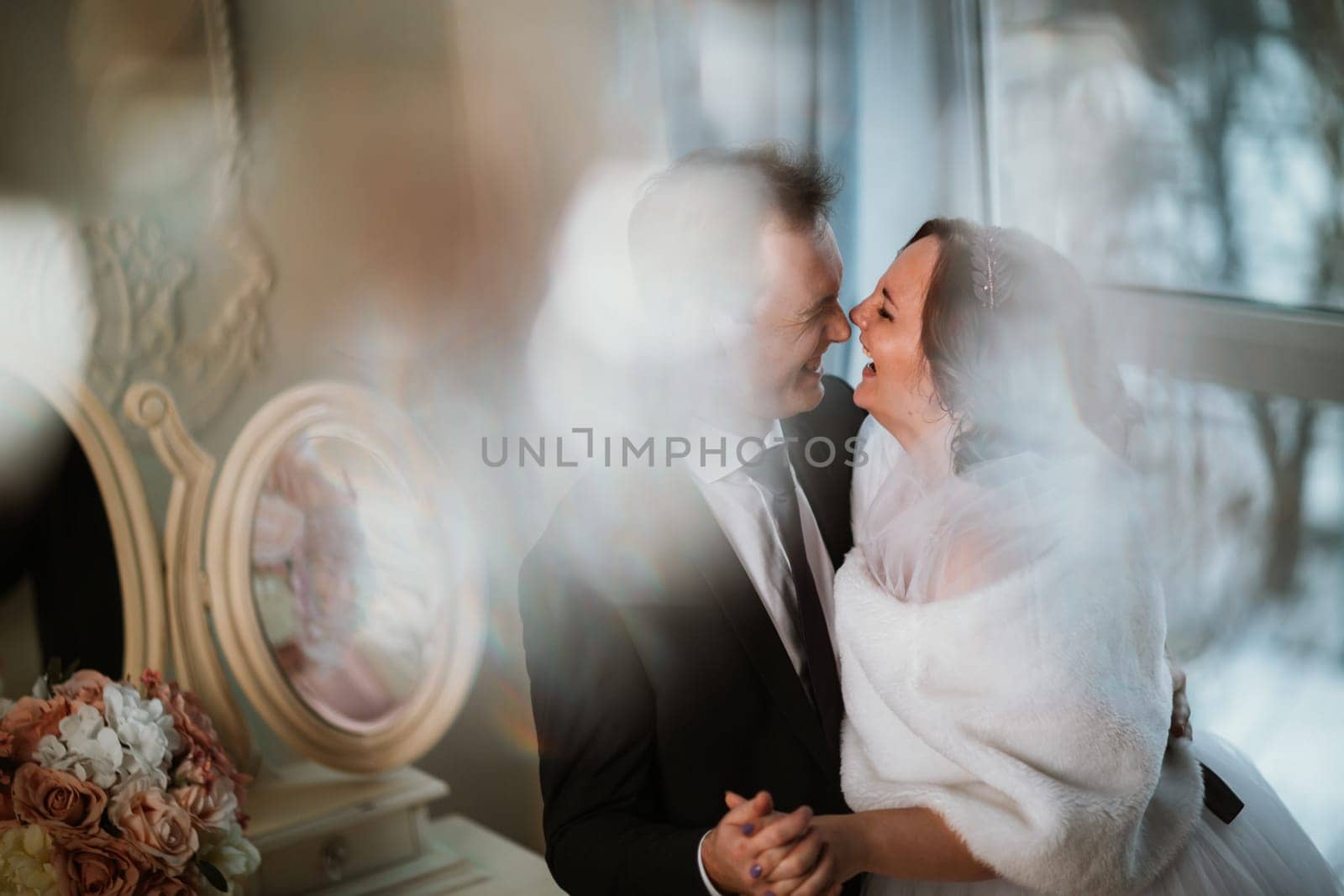 young bride and groom couple in a bright studio photo.