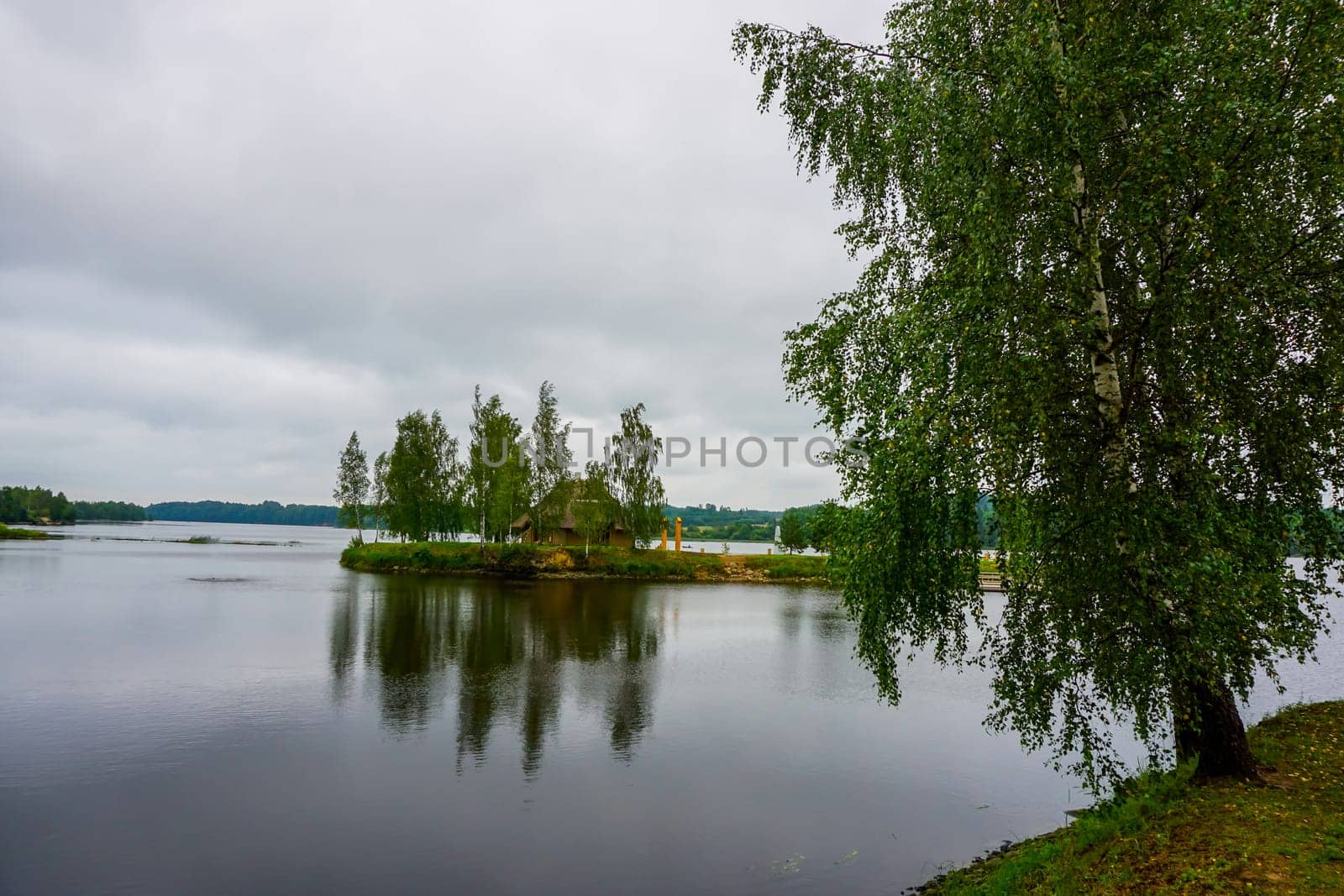 Daugava River near Koknese. Island with sauna in Daugava river. Landscape with birch at Daugava coast. Classical Latvian landscape. Latvian countryside. View of little island in river Daugava, Latvia.