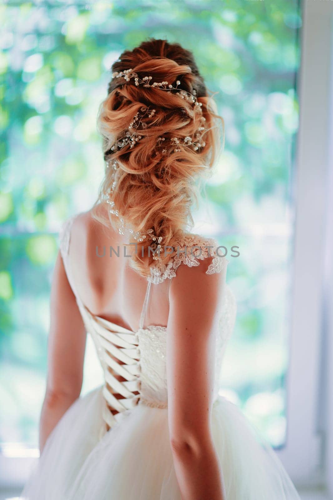 Beautiful young bride on blurred background.