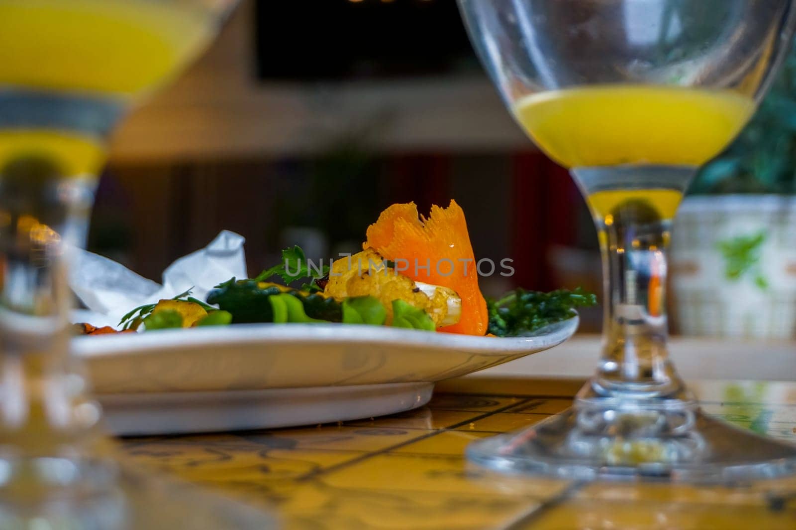 Plate with salmon salad and orange juice. Lunch in cafe Liepkalni, Latvia. Dinner in cafe.