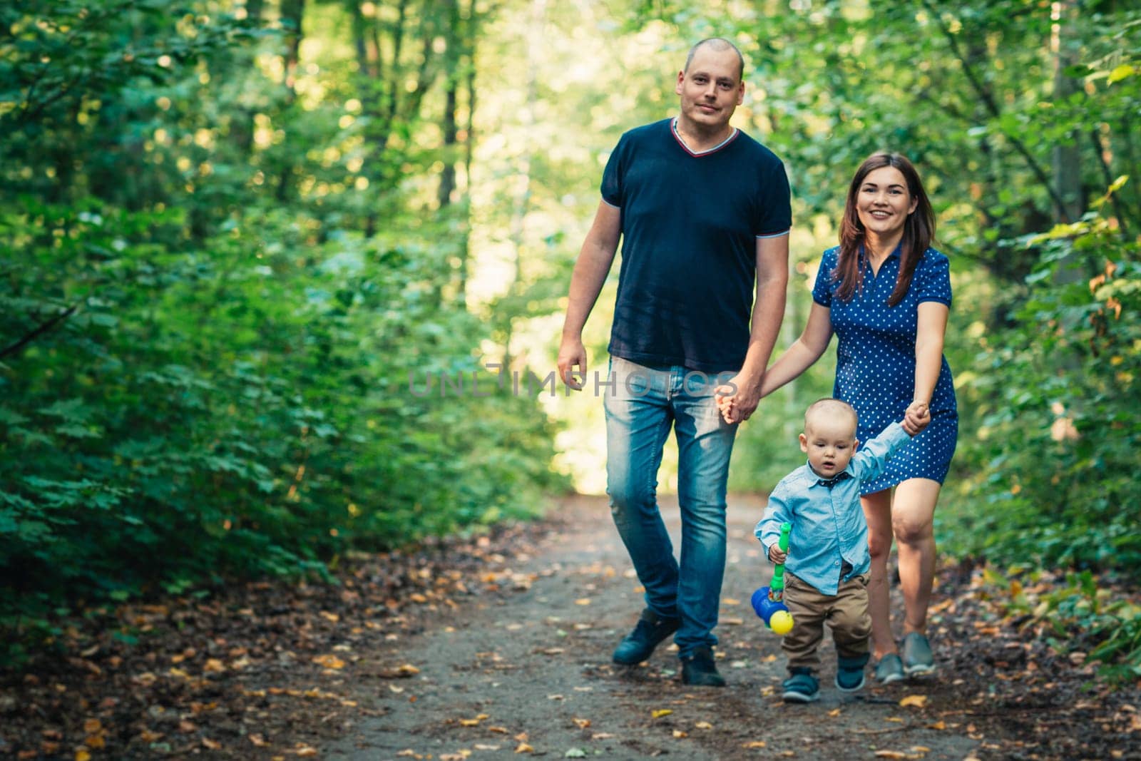 happy family with son on background forest