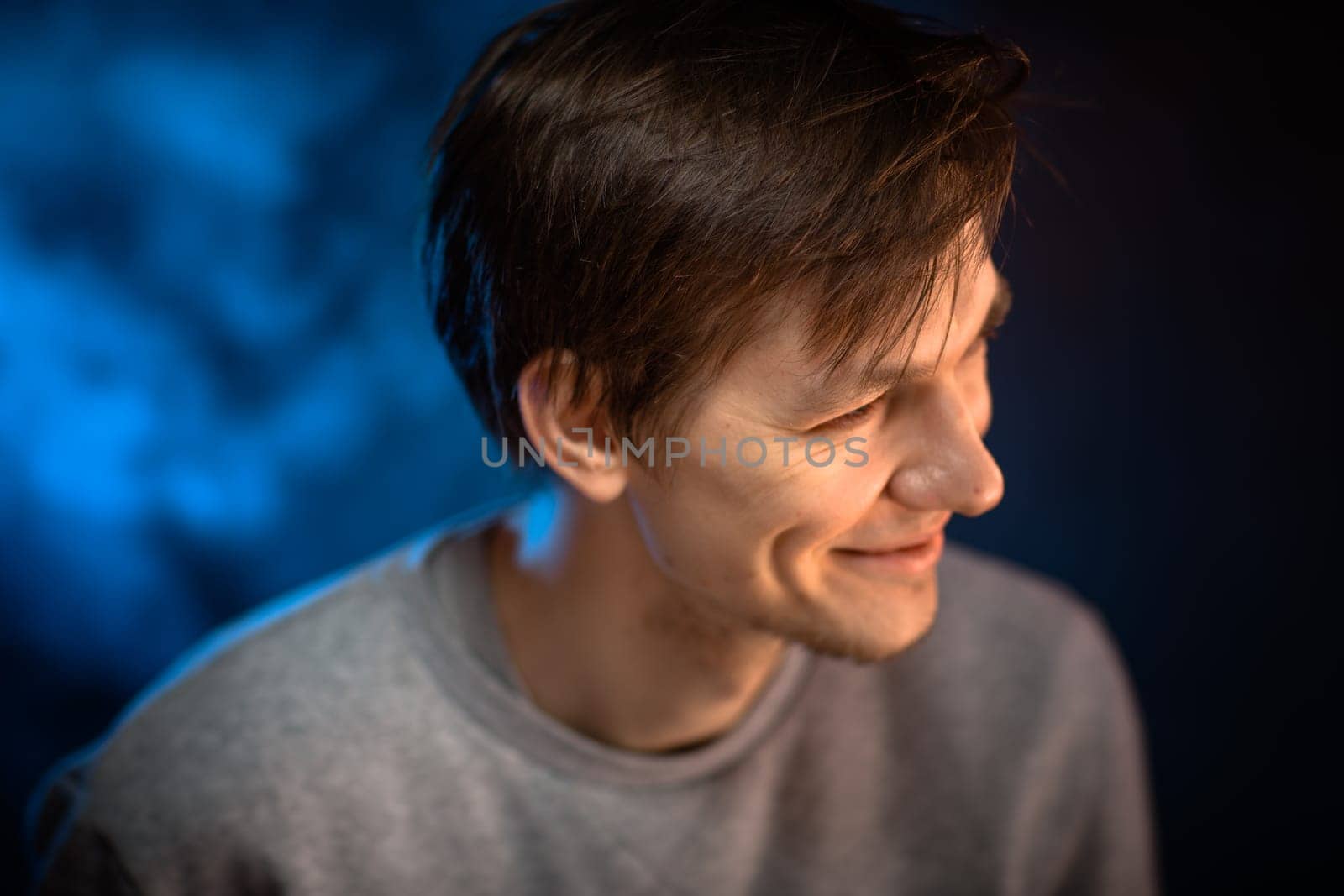 portrait emotional young man on blue background.