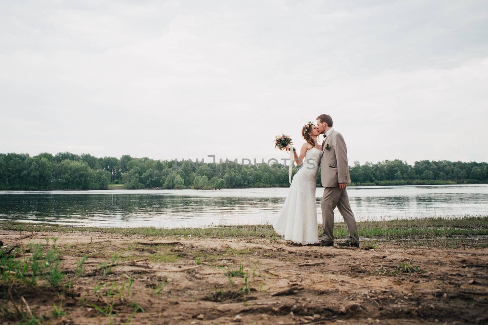 young couple in the style of provence on background of river.