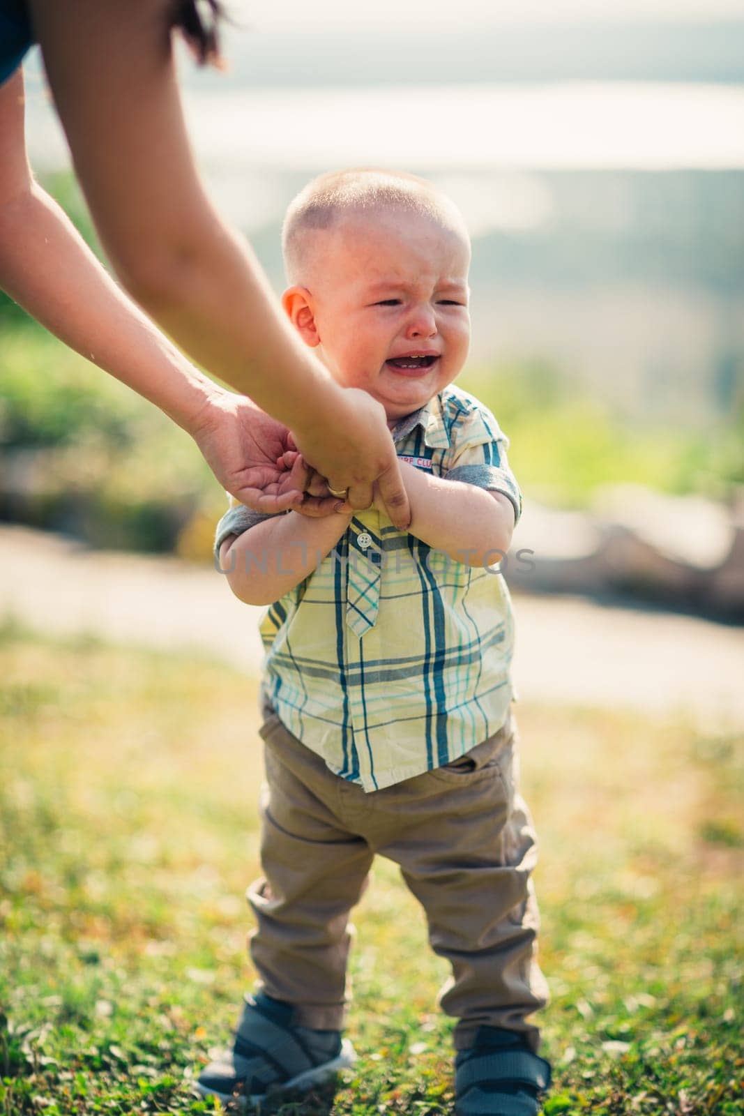 crying toddler baby on nature background.