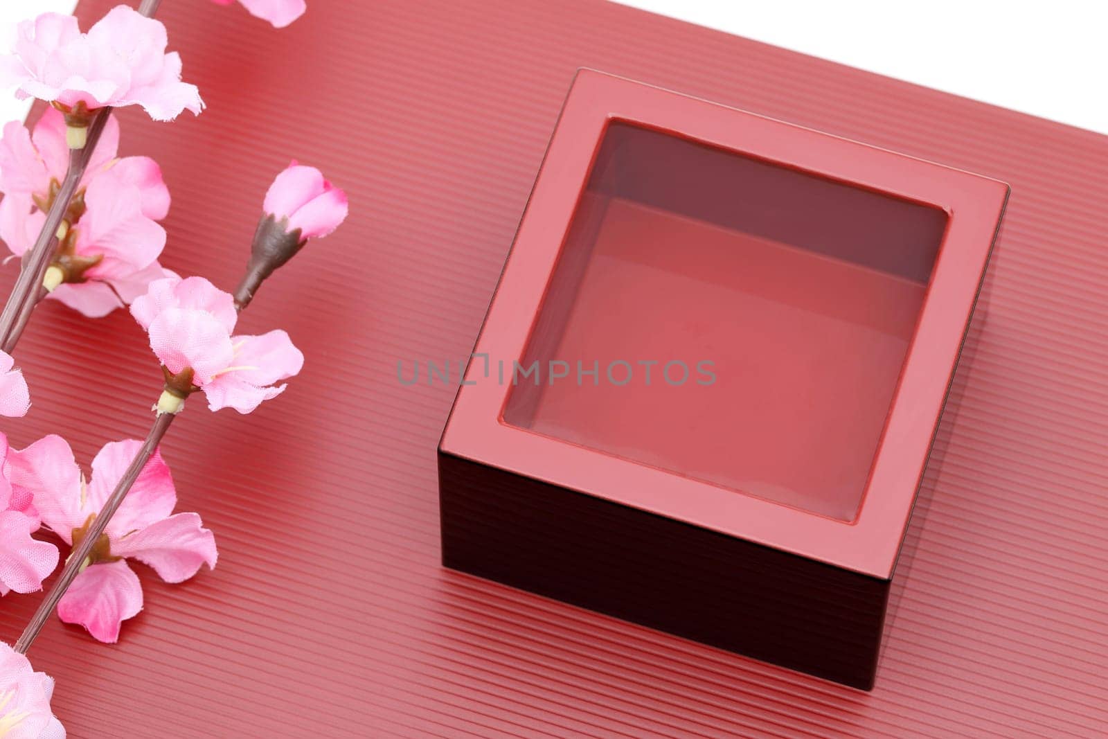 Japanese wooden box masu with sake on a wooden plate