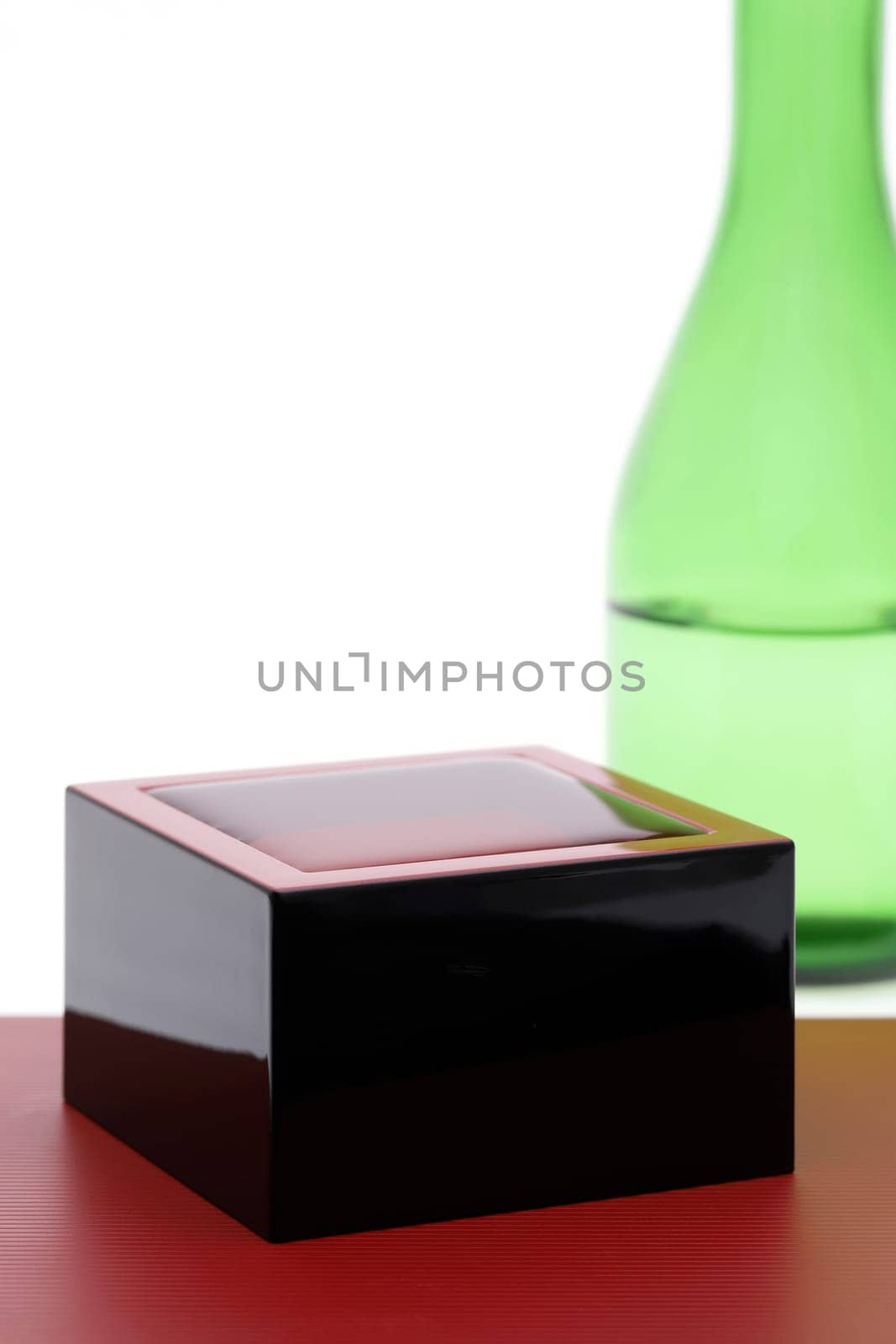 Japanese wooden box masu with sake isolated on white background