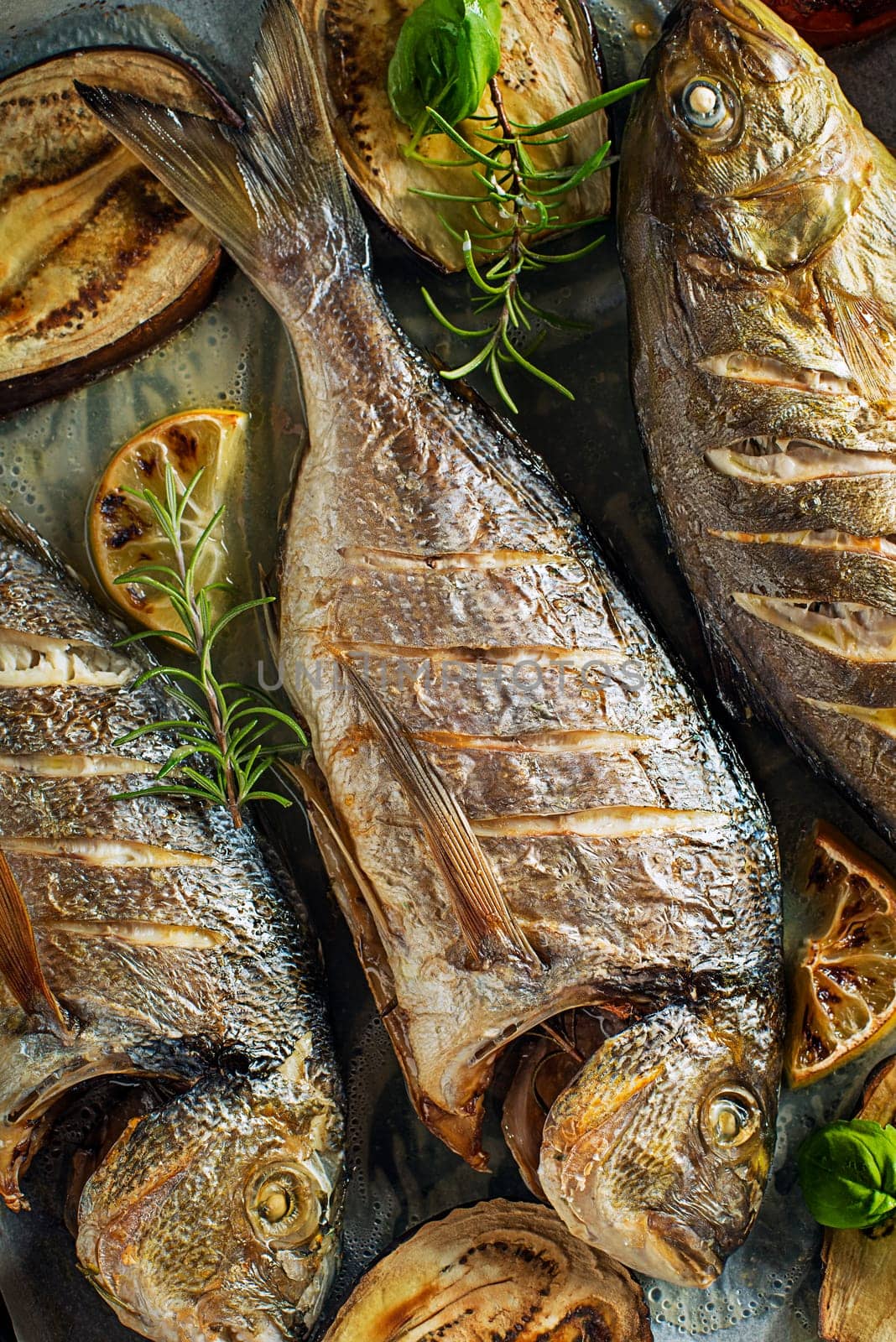 Grilled Gilt-head bream fish with vegetables and spices