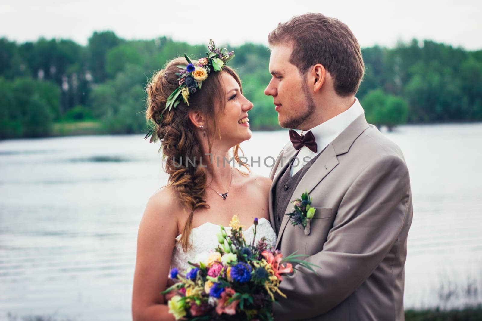 young couple in the style of provence on background of river.