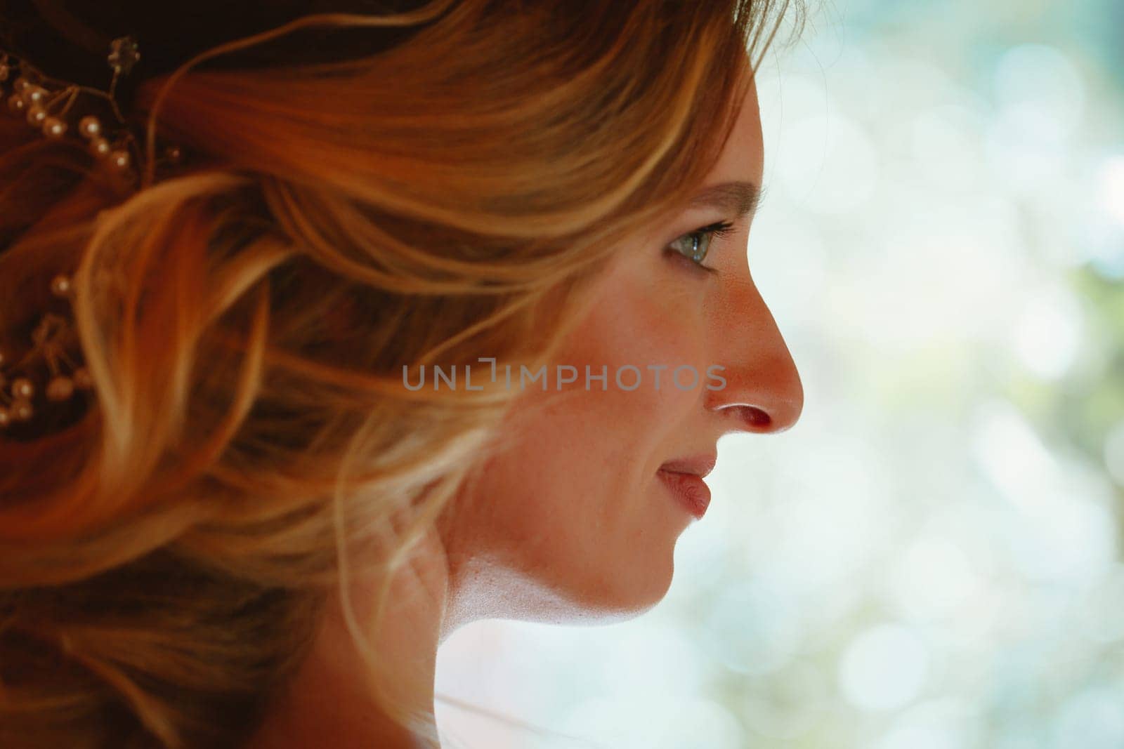 Beautiful young bride on blurred background.