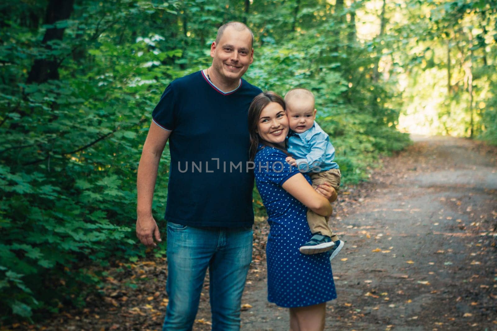 happy family with son on background forest