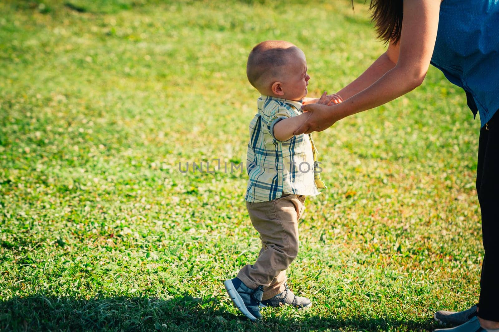 crying toddler baby on nature background.