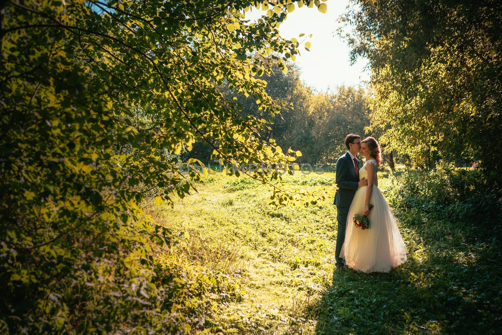 bride and groom on background summer forest.