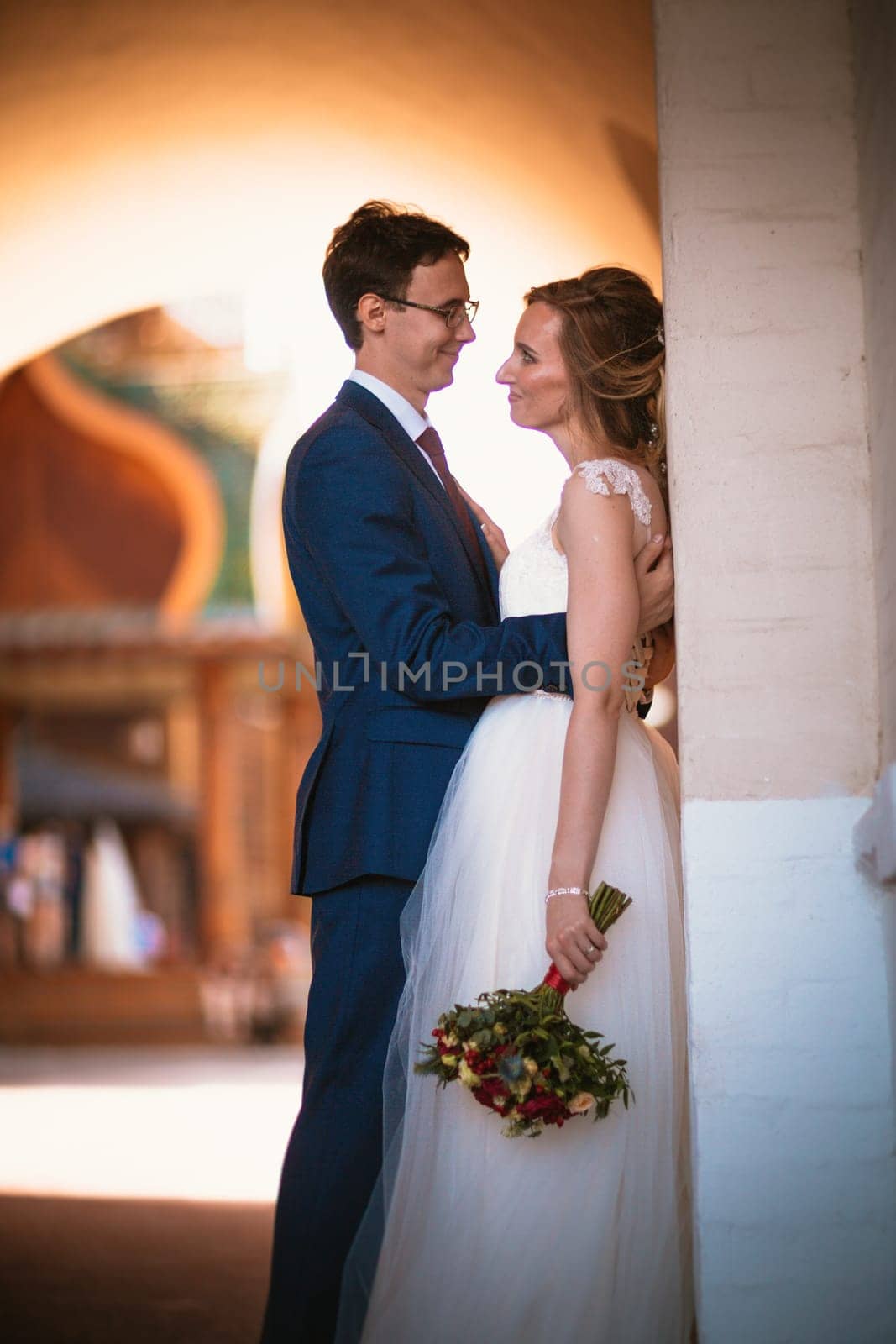 bride and groom on the background of the Kolomna Palace.