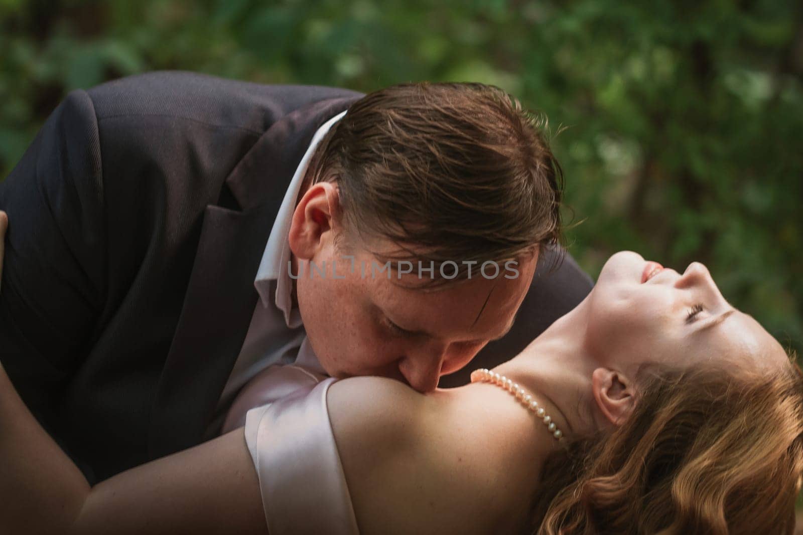 bride and groom dancing in the forest background and sunlight.