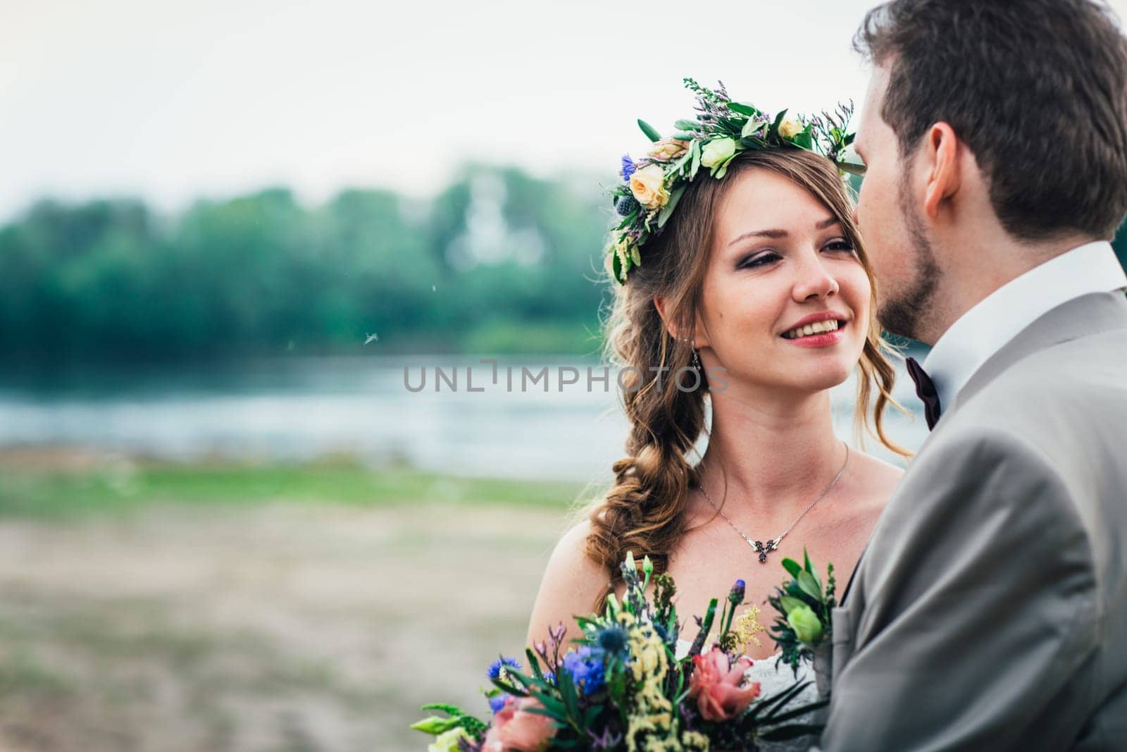 young couple in the style of provence on background of river.