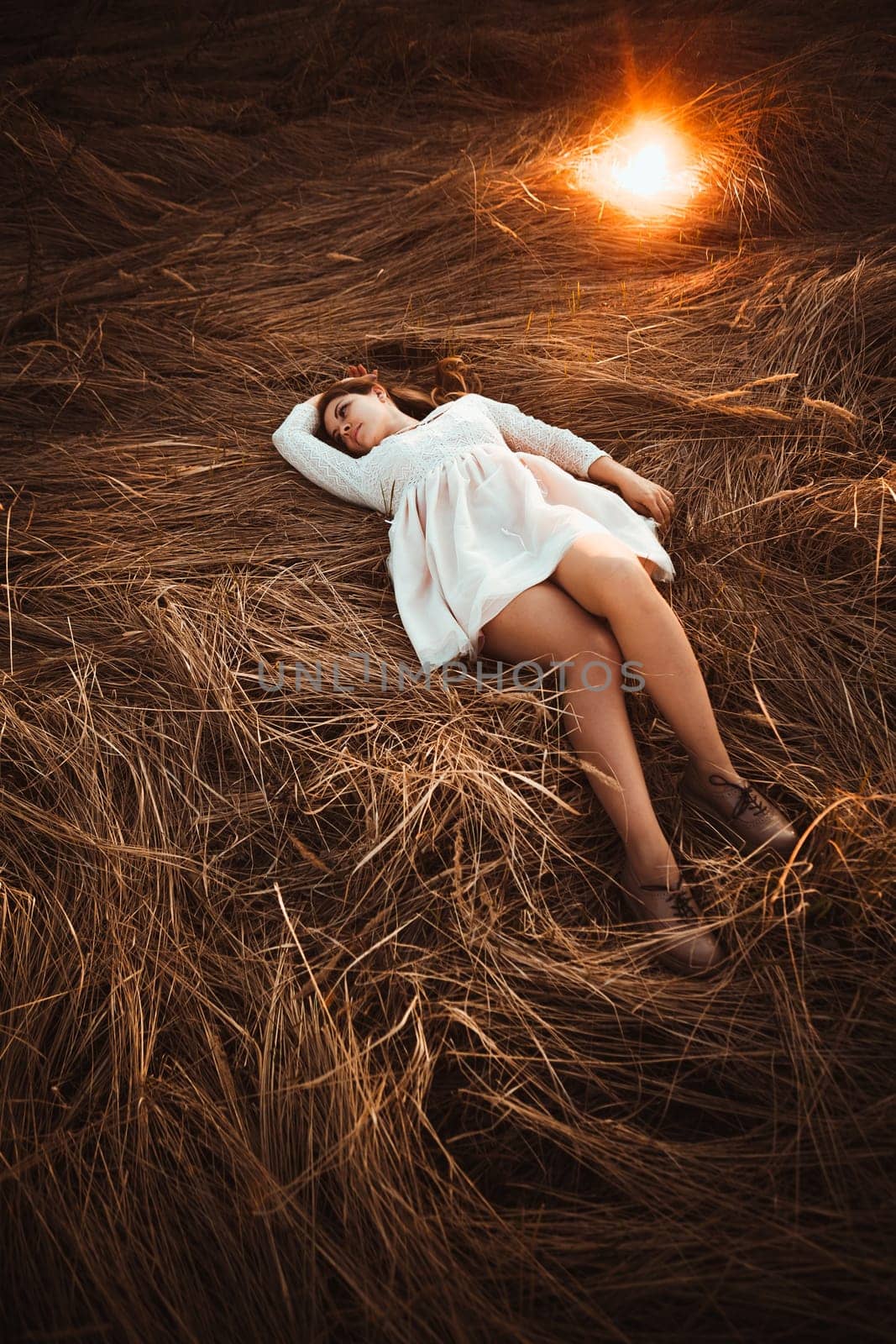 girl lying on the field on a sunset background.