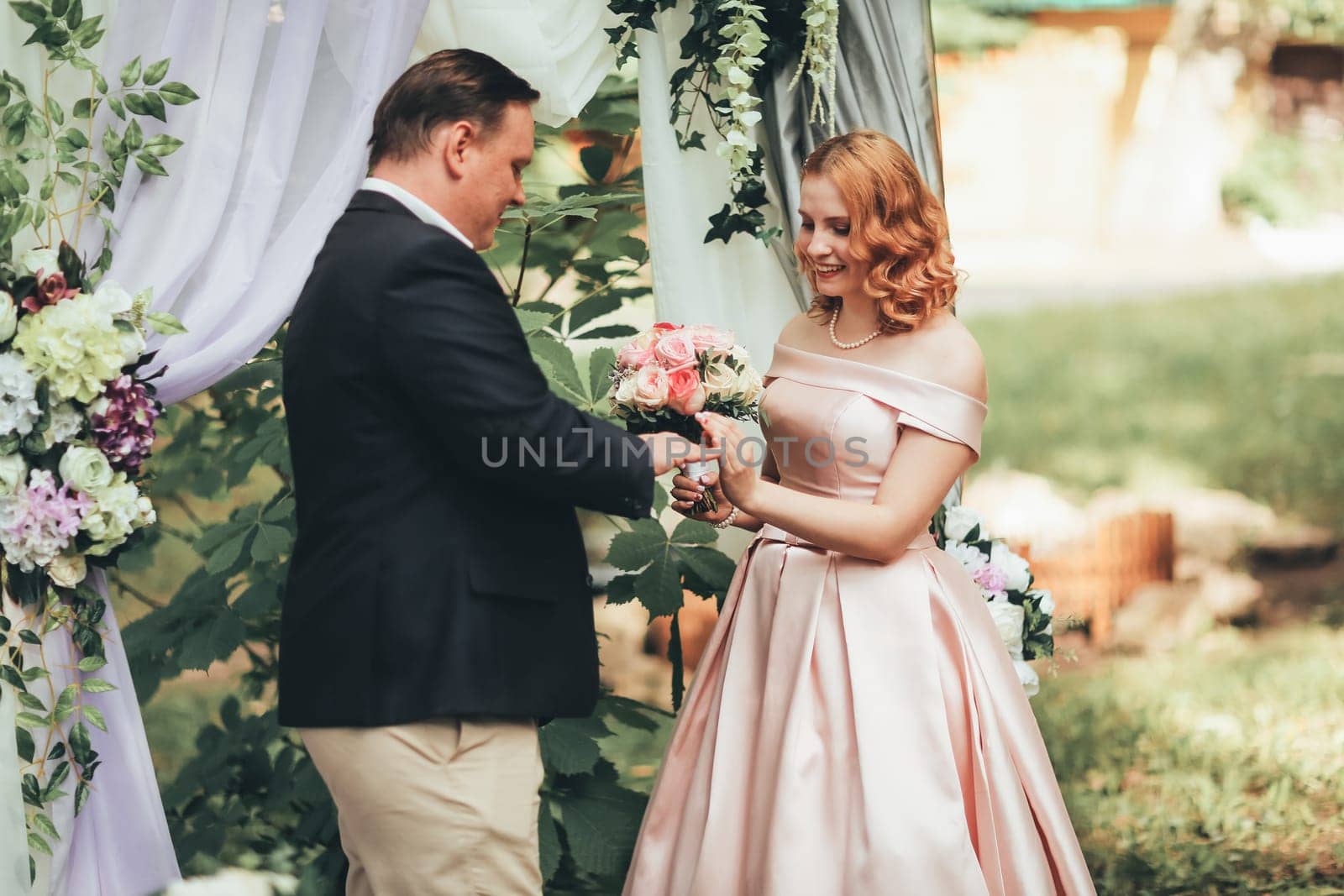 bride and groom on wedding ceremony on background nature.