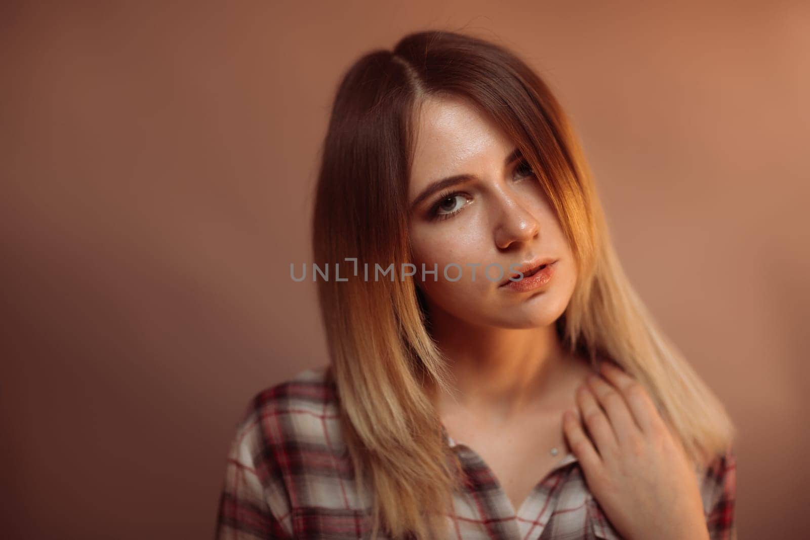portrait smiling girl on orange background in studio.