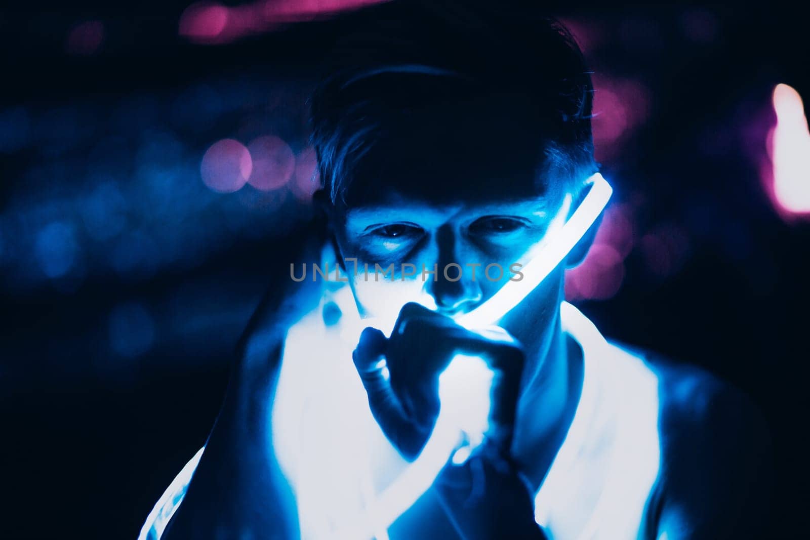 Portrait man Strip Light LED tape on dark color background.