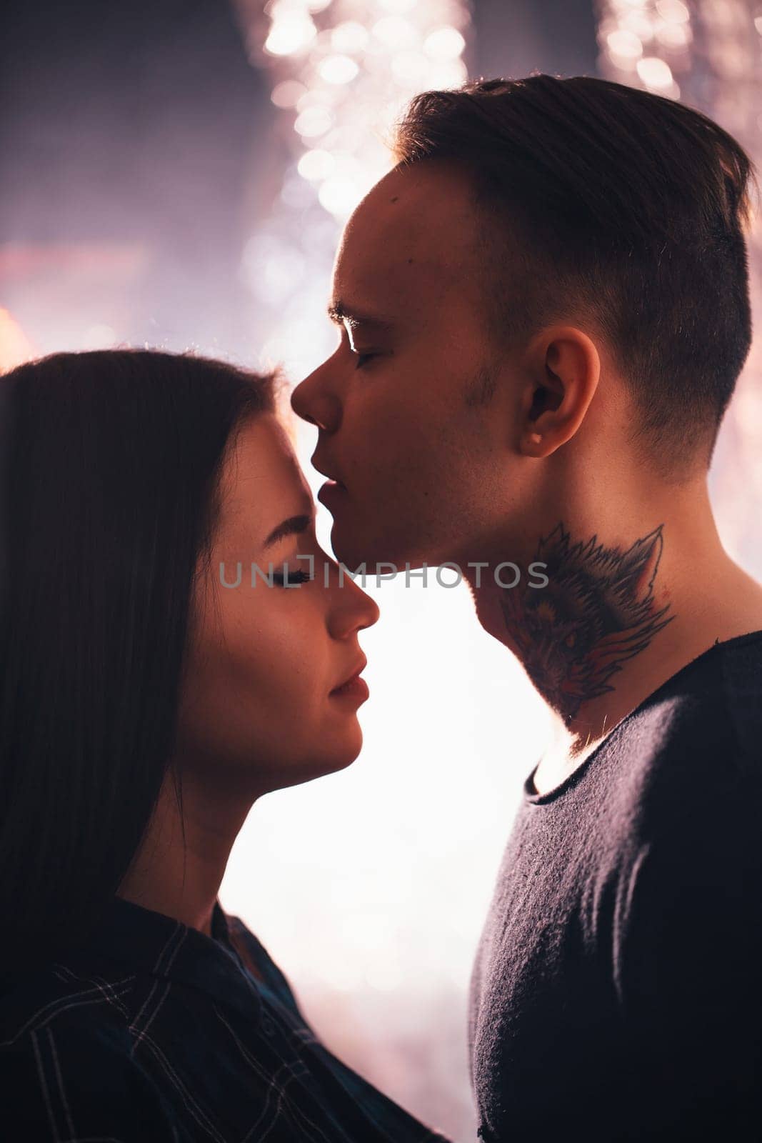 guy and the girl kiss closeup on a light background