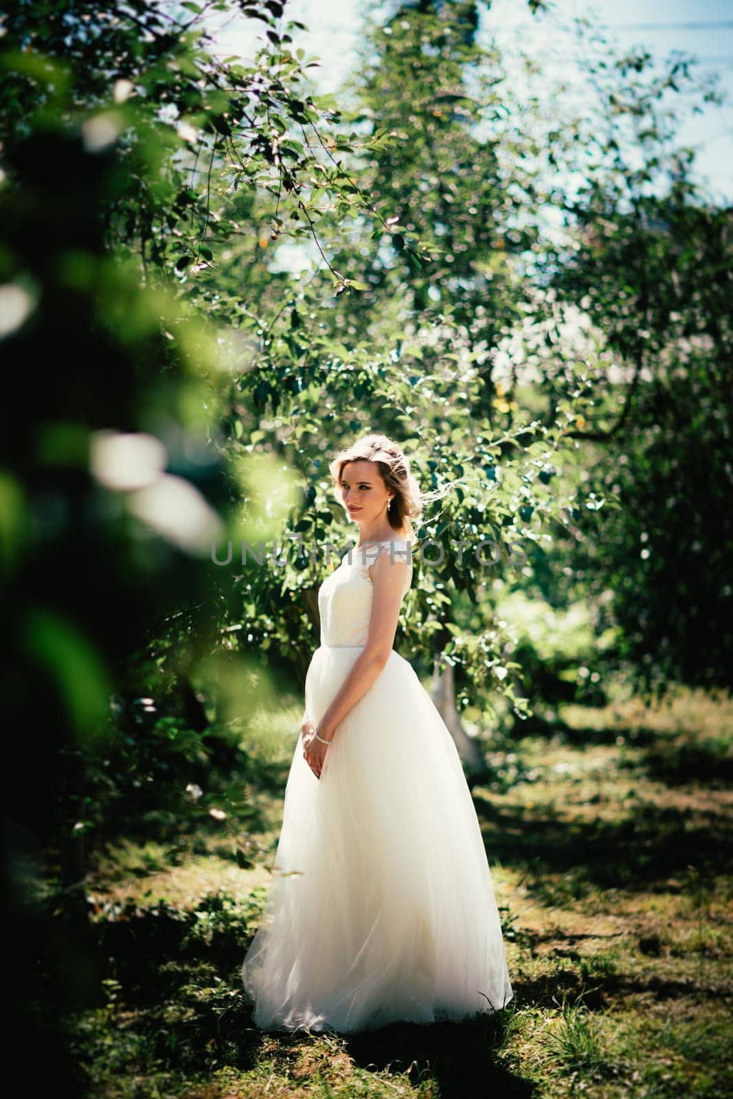 beautiful young bride in the garden background.