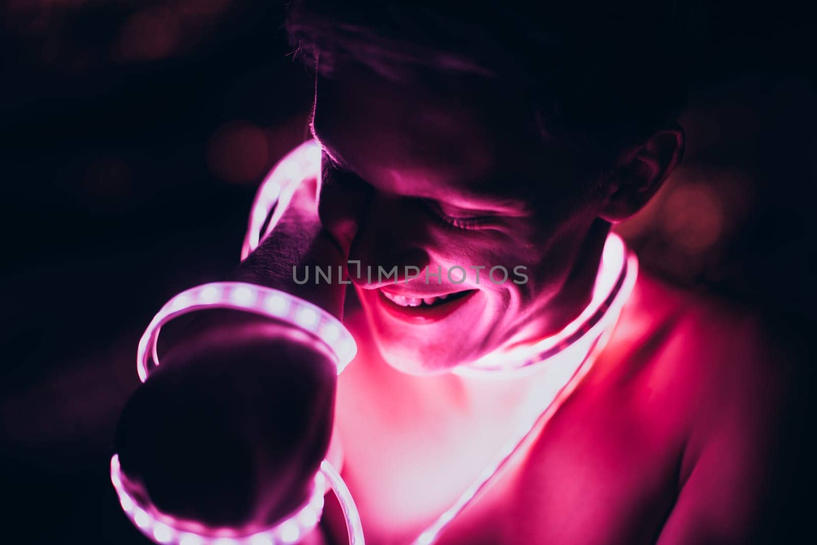 Portrait man Strip Light LED tape on dark color background.