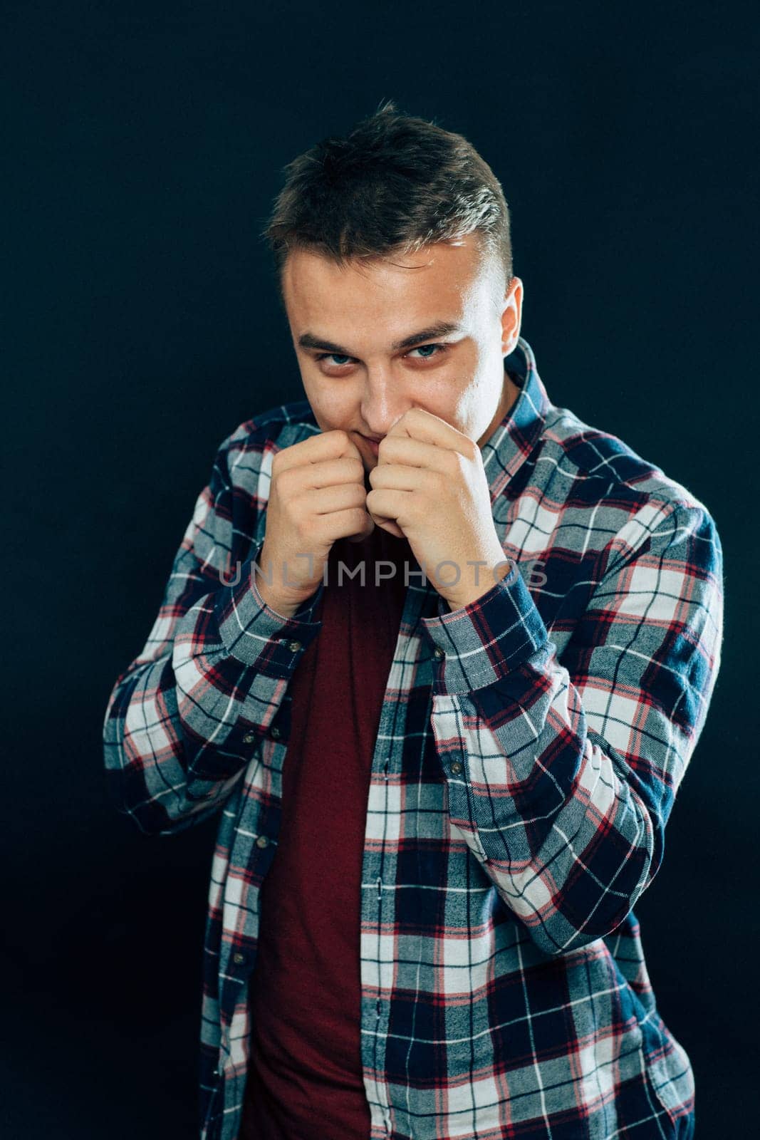 portrait of a young man on a dark background.