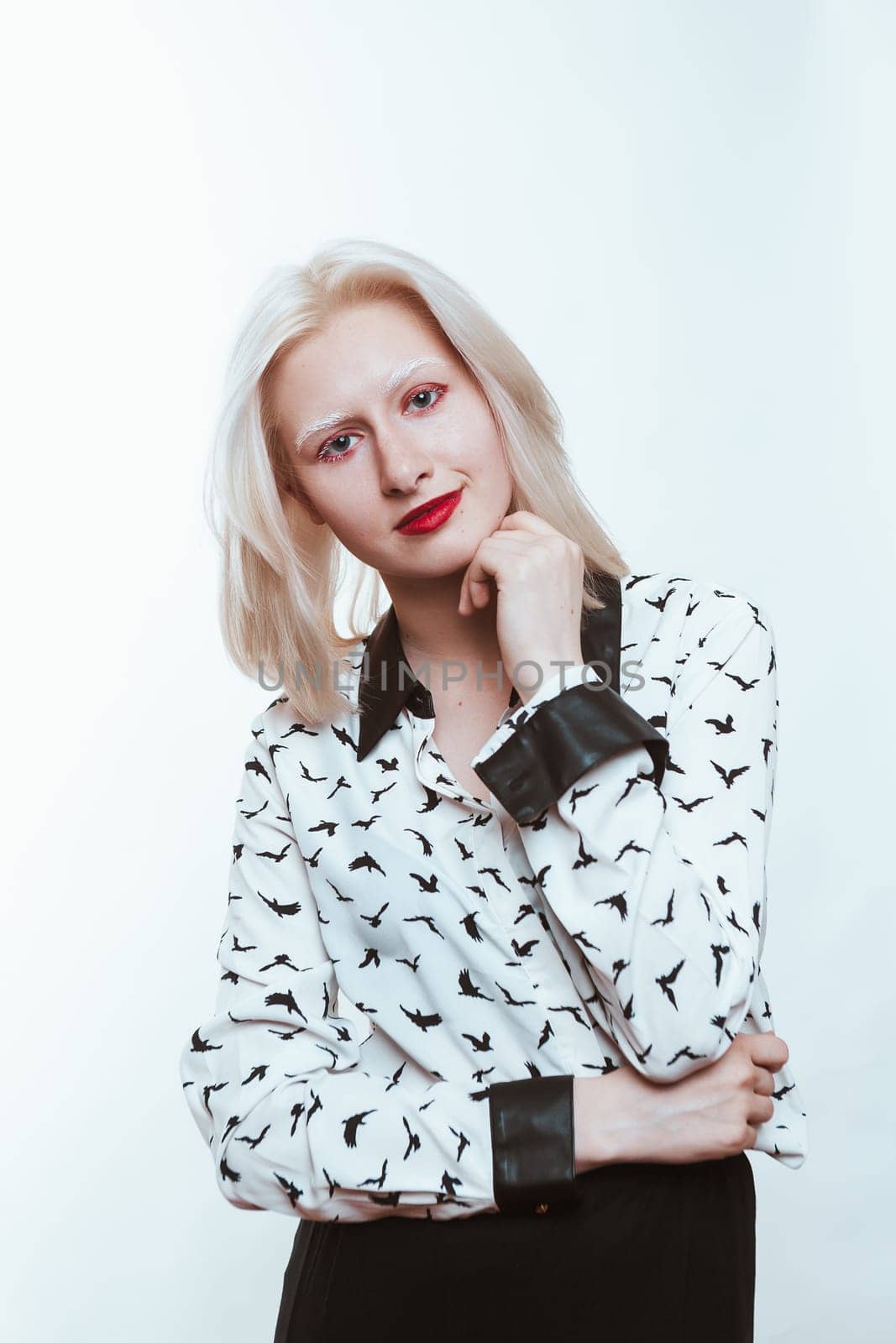 portrait blonde albino girl in studio on white background.