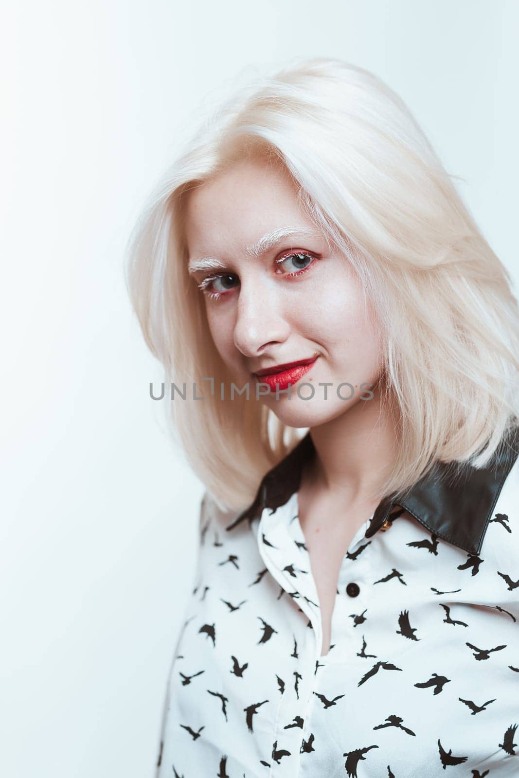 portrait blonde albino girl in studio on white background.