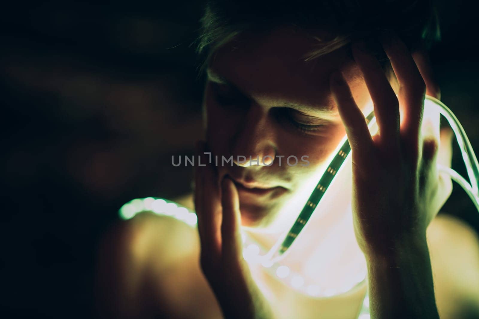 Portrait man Strip Light LED tape on dark color background.