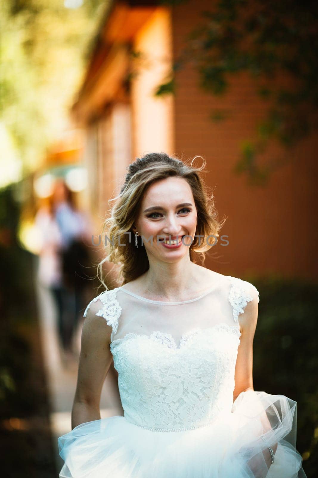 Beautiful young bride on blurred background.