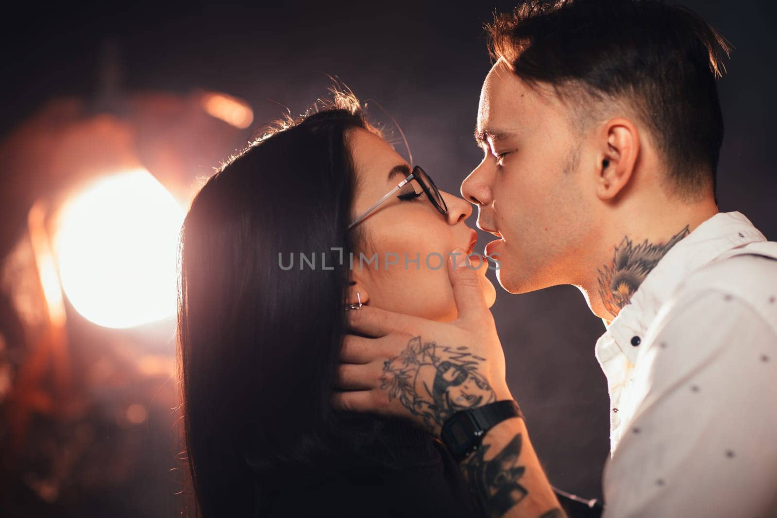 portrait couple in fashionable clothes on a dark smoky background.