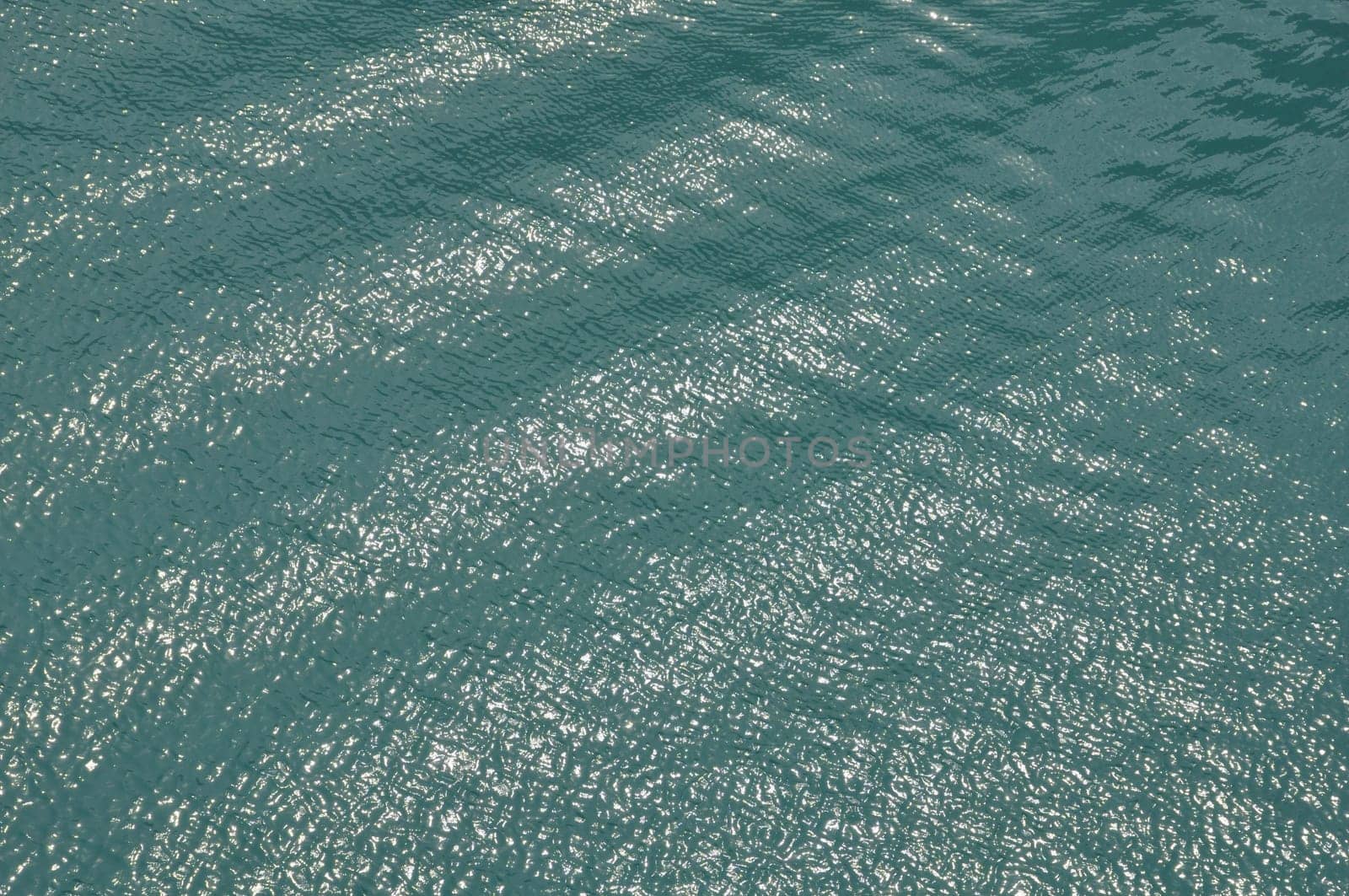 Light reflections on sea water on sunny summer day.