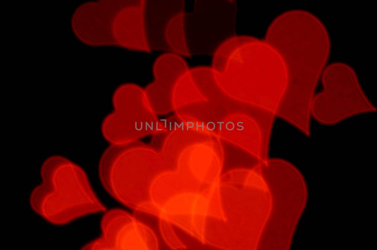 Romantic red hearts on black background. Abstract love background.