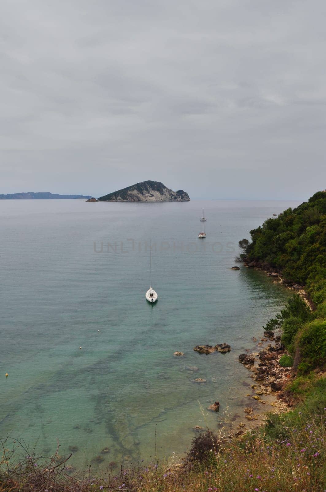 Sea and sky horizon small boats and distant island landscape. Zakynthos, Greece.