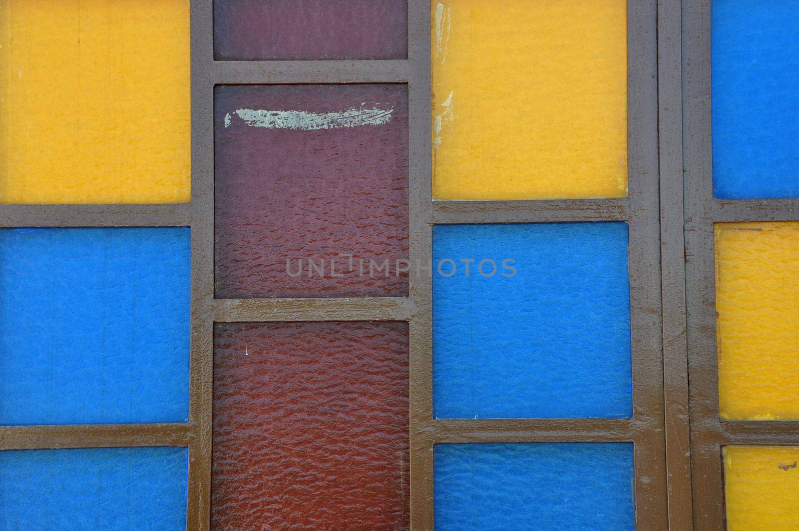 Colorful stained glass abstract squares on church window.