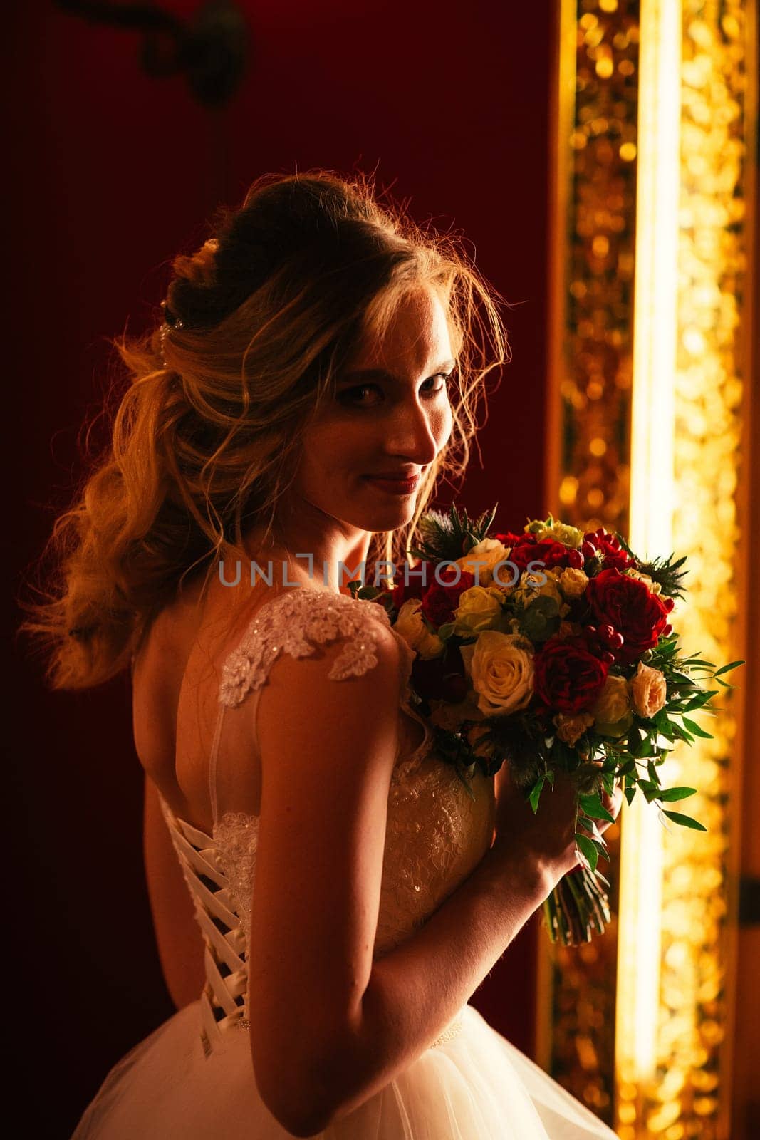 Portrait young beauty bride near the window.