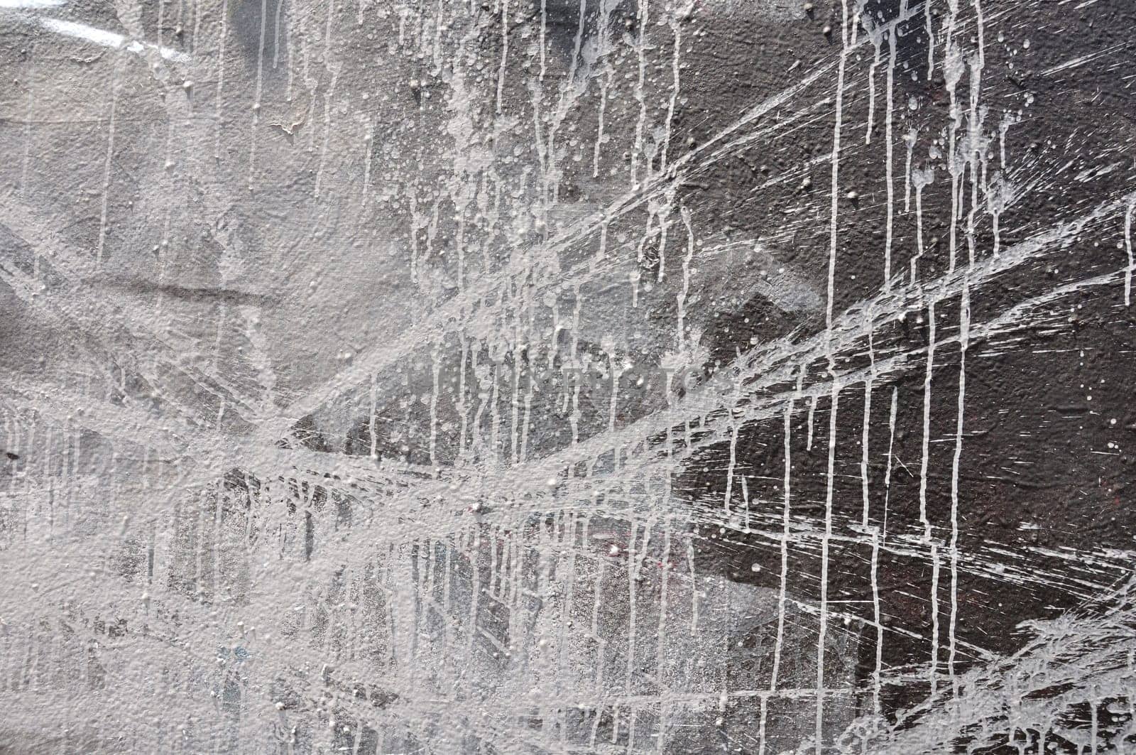 White paint smudged over black wall. Abstract background.