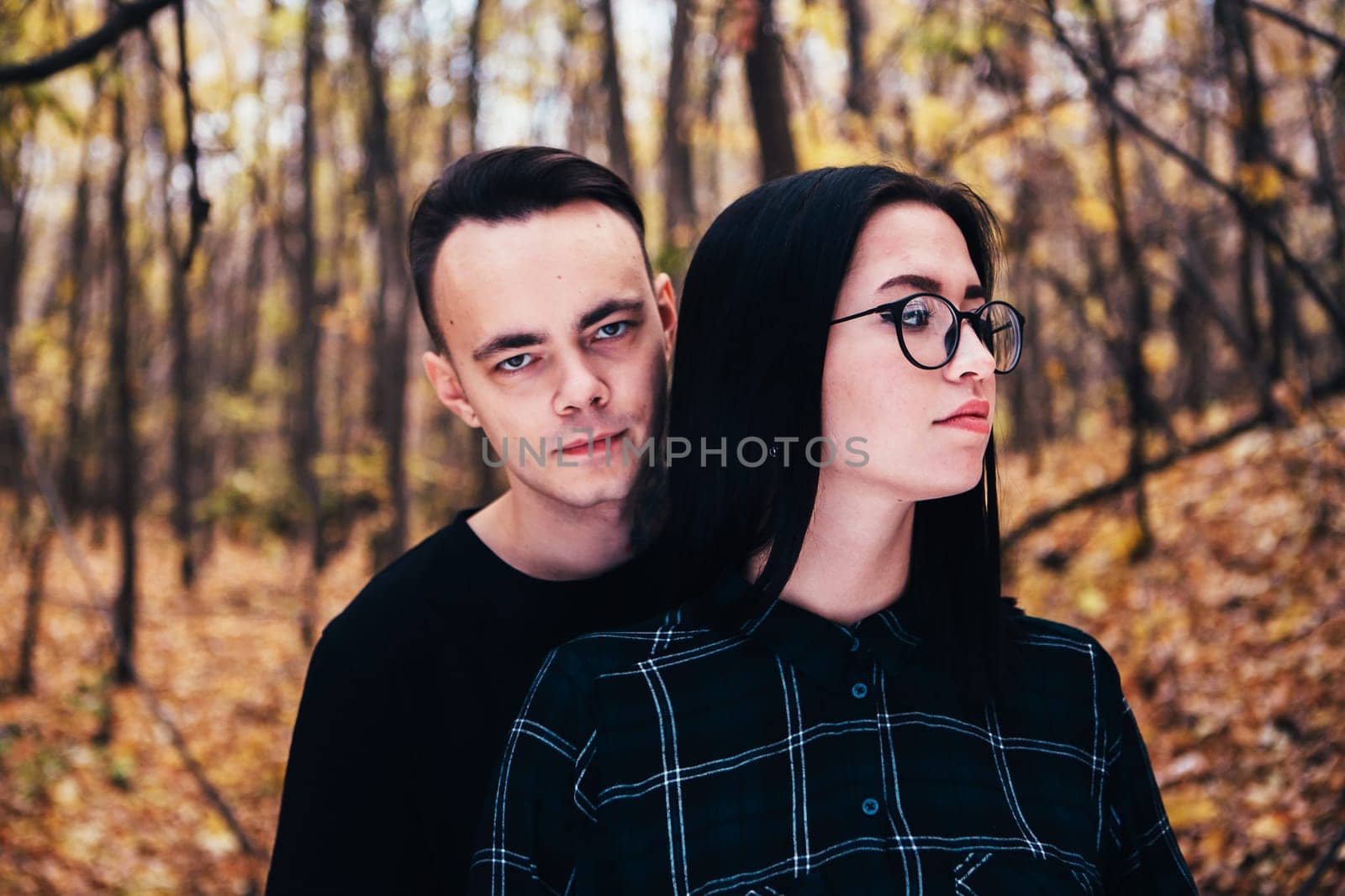man and woman in the autumn forest
