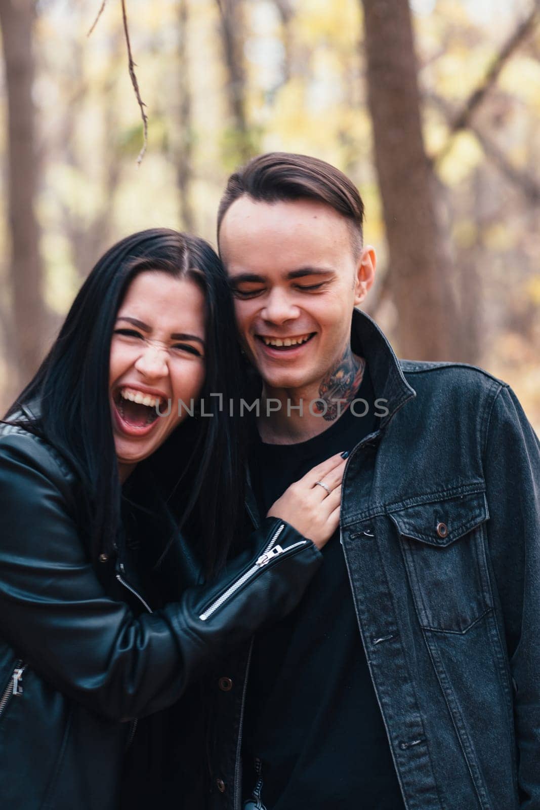 portrait of a young woman and a man walking in the autumn forest.