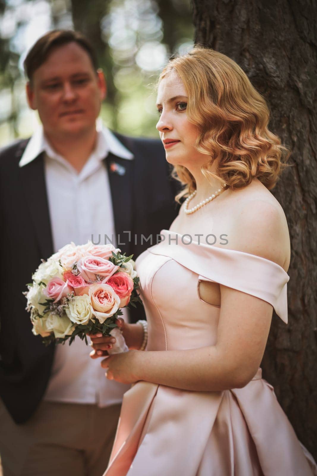bride and groom kiss on the background of trees and forest.