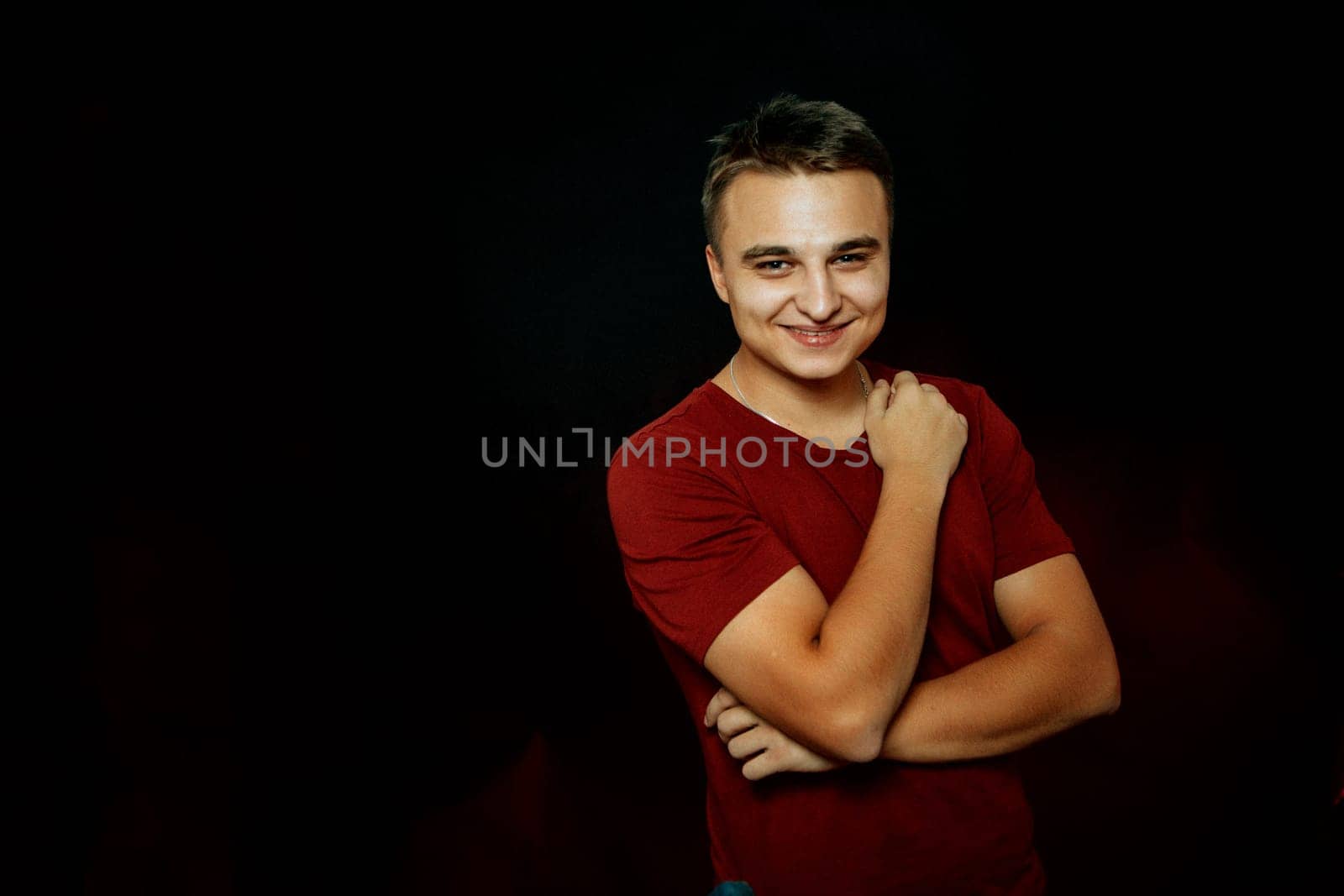 portrait of a young man on a dark background.