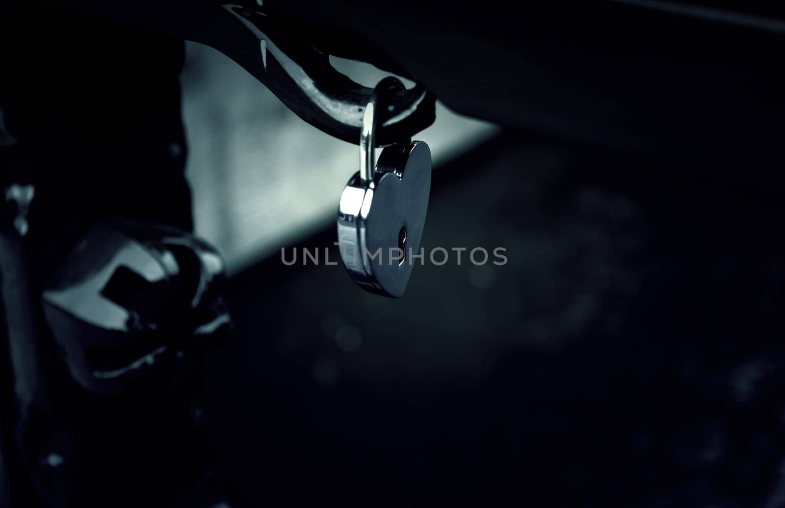Padlock hanging on bridge, symbol of love, union