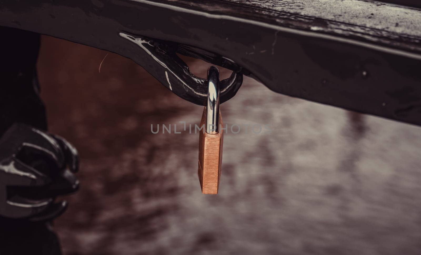 Padlock hanging on bridge, symbol of love, union