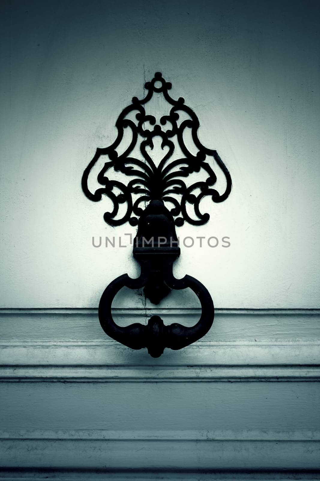 White wooden door with caller ornament, construction