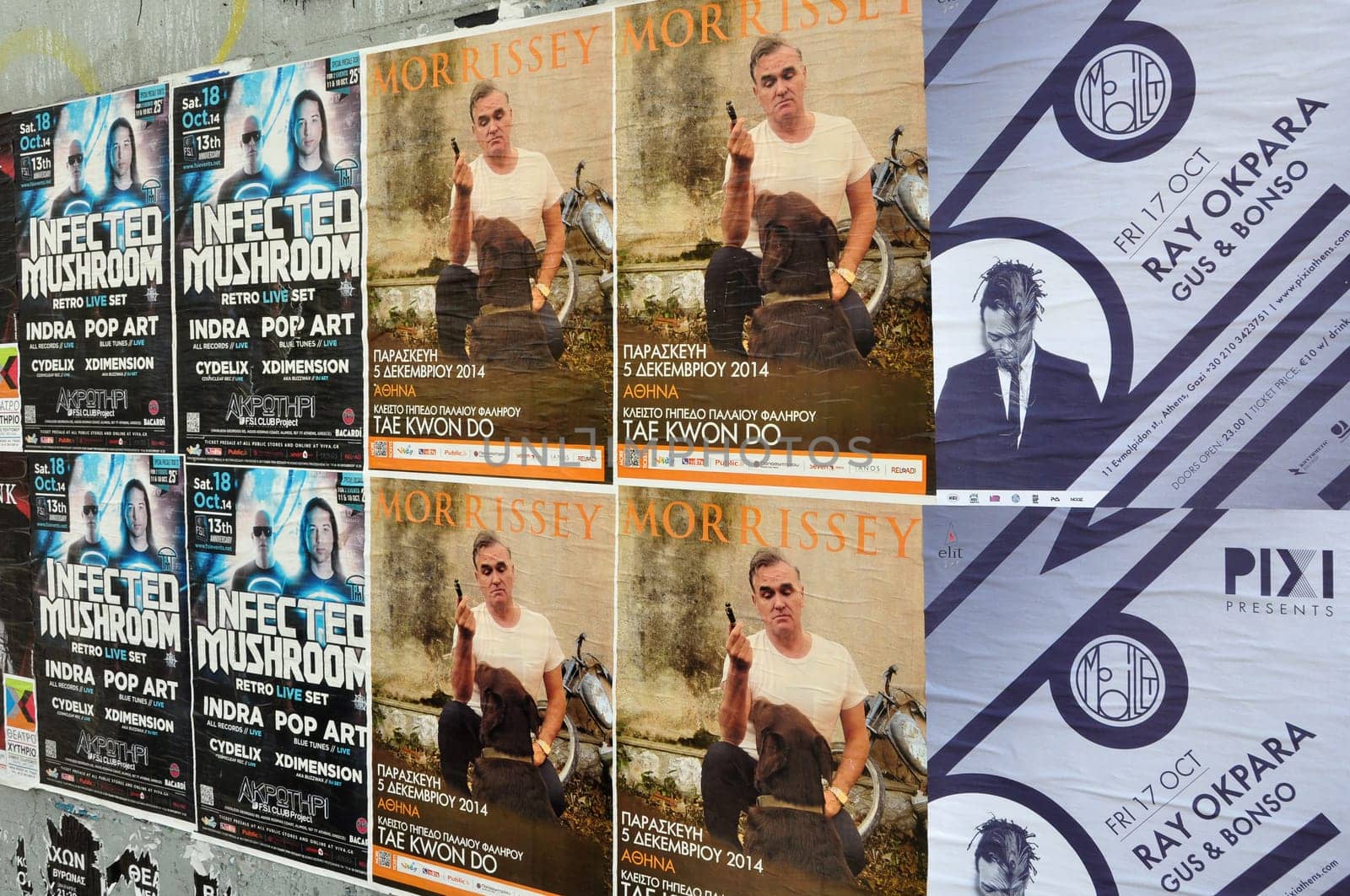 ATHENS, GREECE - OCTOBER 15, 2014: Wall plastered with live music concert posters indie rock by Morrissey and dj sets of minimal techno by Ray Okpara and psychedelic trance by Infected Mushroom.