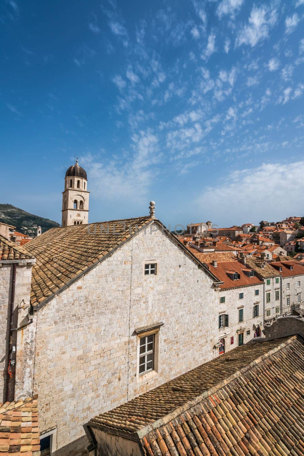 Dubrovnik, Croatia - April 2018 : Church bell tower and rooftops of old houses in Dubrovnik, viewed from the Old Town fortified walls